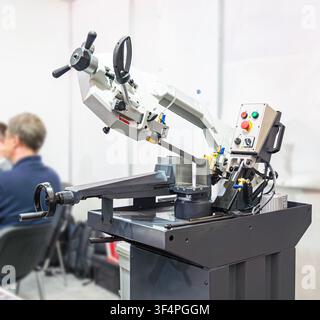 Industrial metal cutting bandsaw machine with an adjustable vice and a control panel, designed for precise cutting of steel bars and profiles in works Stock Photo