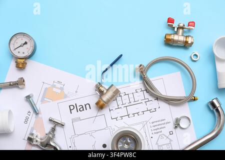 Composition with plumbers items and house plans on blue background Stock Photo