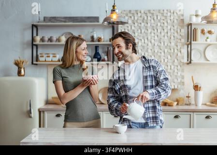 Happy Caucasian Couple Preparing Breakfast Together In Kitchen, Smiling Stock Photo