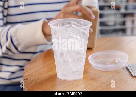 A cup of ice cubes on a table in a cafe Stock Photo