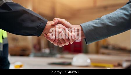 People, meeting or civil engineer with handshake for construction partnership or deal together. Architect, contractor or employees shaking hands with Stock Photo