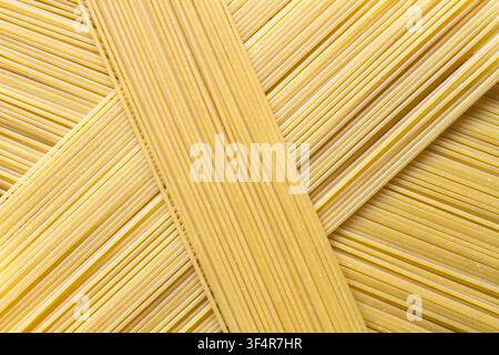 Spaghetti texture. Background texture of pasta. Raw spaghetti close-up. Stock Photo