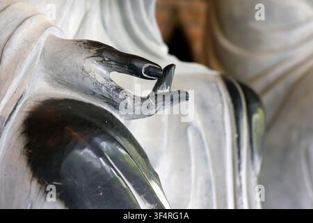 Bai Dinh Pagoda. Gallery of the 500 Arhats. The white marble monks are enlightened disciples of the Buddha. A close-up of the marble, weathered by tim Stock Photo