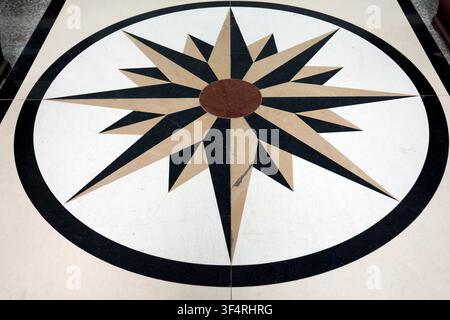 A compass rose pattern adorns the marble floor, symbolizing direction and navigation. Thong Nhat, Vietnam. Stock Photo
