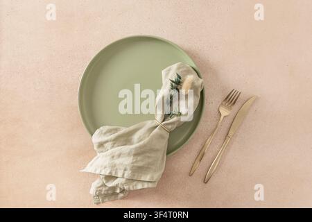 Minimal autumn table setting with green plate white pumpkins and copy space Stock Photo