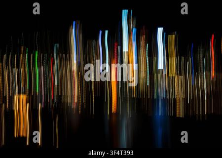 Vertical light trails on dark background Stock Photo