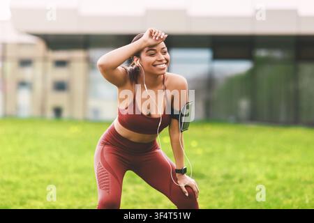 Smiling African American Woman Running Outdoors In Activewear, Weight Loss Concept Stock Photo