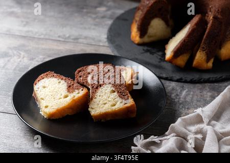 Marble bundt cake sliced on wooden table Stock Photo