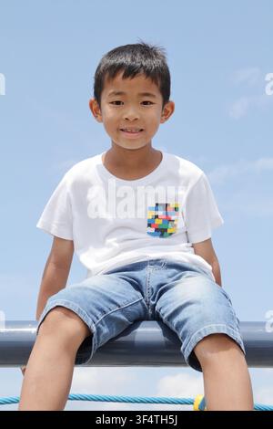 Japanese boy under the blue sky in summer (third grade at elementary school) Stock Photo