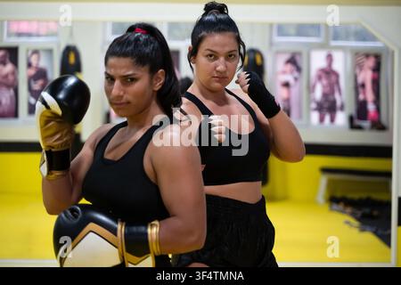 Two Women Boxing Partners Training Together in Gym for Fitness and Fight Preparation Stock Photo