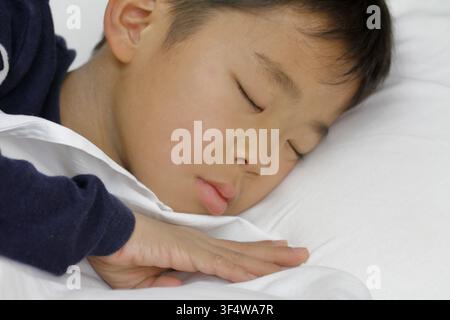 sleeping Japanese boy (third grade at elementary school) Stock Photo