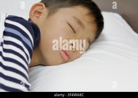 sleeping Japanese boy (third grade at elementary school) Stock Photo