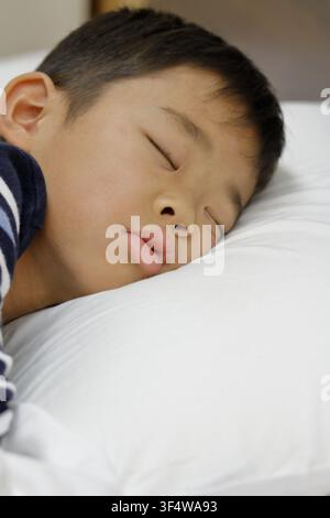 sleeping Japanese boy (third grade at elementary school) Stock Photo