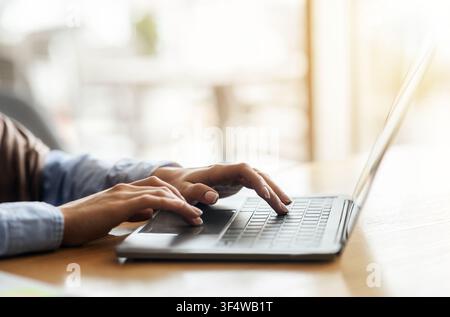 Female hands typing on laptop over blurred background Stock Photo