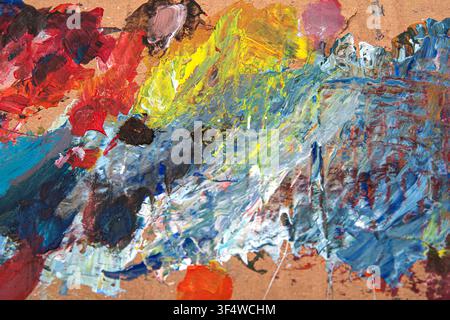 Colorful Mixed Oil Paint Strokes Creating Abstract Texture on Used Artist Palette Stock Photo