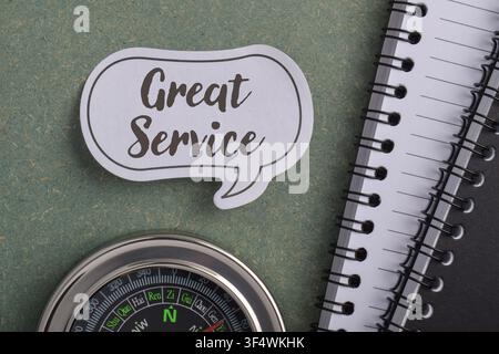 Great service customer satisfaction concept with speech bubble, compass, and notebook representing business support, client experience, communication, Stock Photo