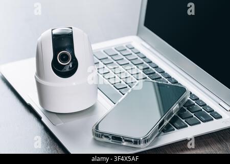 Modern Smart Home Security Technology Device, CCTV with laptop and Smart Phone. Stock Photo