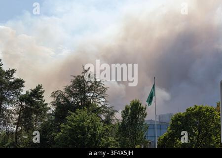 Smoke from the wildfire on 13th July 2026 billows behind the INSEAD campus in Fontainebleau, France which had to be evacuated. Stock Photo