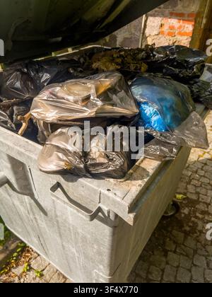 The dumpster is packed to the brim with waste Stock Photo