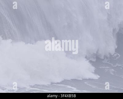 Powerful ocean wave crashing against the surface, creating massive white foam and water spray Stock Photo