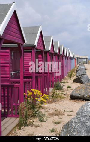Beach huts on a sandy beach Stock Photo