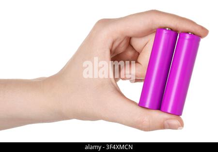 Woman holding alkaline batteries on white background, closeup Stock Photo