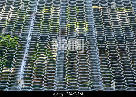 Close up view of galvanized expanded steel grating with repeating geometric mesh pattern used for industrial flooring, walkways and construction appli Stock Photo
