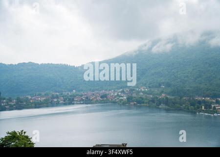 Misty lake and mountains before rainstorm, Caslano, Switzerland Stock Photo