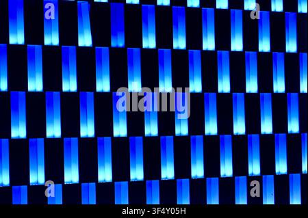 A captivating image of blue illuminated bars set against a dark background, showcasing a modern and futuristic aesthetic with clean lines and vibrant colors. This visually striking. Stock Photo
