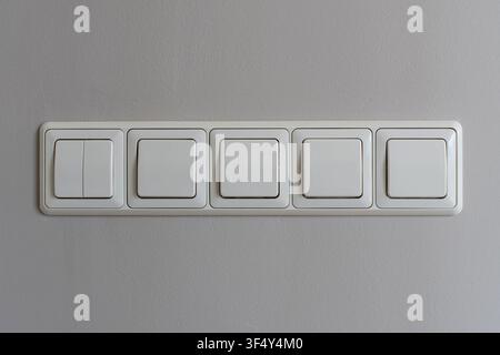 horizontal 5-fold flush-mounted rocker light switch combination Stock Photo