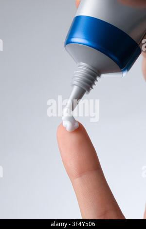 squeezing cream onto the hand, cream on the fingers, applying cream Stock Photo