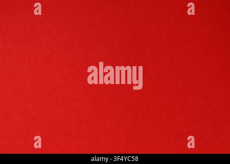 Solid bright red textured paper background with natural grain for design and copy space Stock Photo
