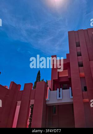 Calpe, Spain - May 27, 2026.The architectural detail shows the striking crimson walls of La Muralla Roja building. A bright blue sky fills the backgro Stock Photo