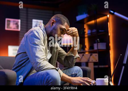 Stressed young adult fears failure and struggling with deadlines, working under pressure and stress from superiors. Frustrated worried employee making mistakes, burnout and tension. Stock Photo