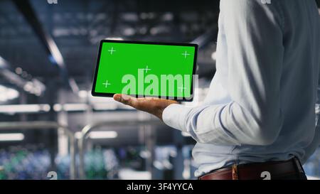 Close up of server farm developer using isolated screen tablet, reviewing AI LLM visualization. Data center IT specialist using mockup device to monitor deep learning systems Stock Photo