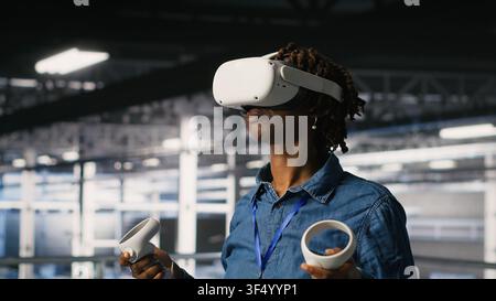 Data center programmer using virtual reality technology to simulate artificial intelligence neural networks. Woman in server farm using VR headset equipment to oversee AI systems Stock Photo