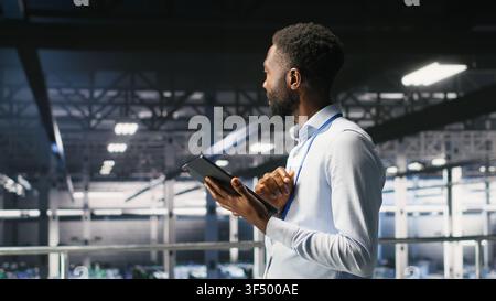 Data center engineer doing maintenance tasks on systems to ensure optimal performance. IT professional reviewing diagnostics and applying patches to server hub improve stability Stock Photo