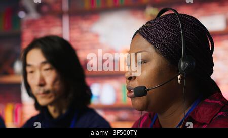 Senior account manager teaching intern how to talk with customers to identify sales opportunities. Experienced team leader helping new trainee in office to generate leads, camera A Stock Photo