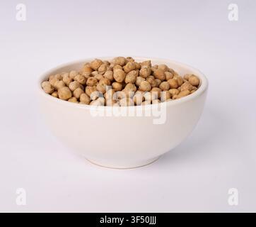 White ceramic bowl filled with dried chickpeas isolated on white background Stock Photo