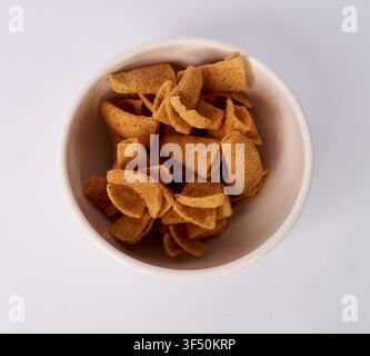 Top view of crunchy cone shaped corn chips isolated on white background Stock Photo