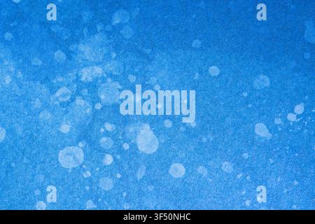 Close-up of blue cardstock featuring a printed watercolor design with soft white speckles and subtle blended color variations. High-resolution texture Stock Photo