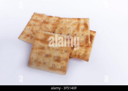 Several crispy square crackers arranged on a clean white background Stock Photo
