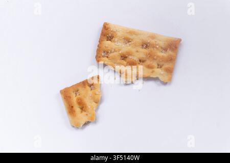 Broken Crispy Crackers on White Background Stock Photo