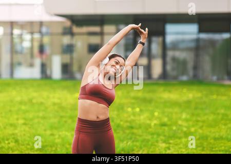 Happy African American Woman Stretching Outdoors In Athletic Wear, Fitness Concept Stock Photo