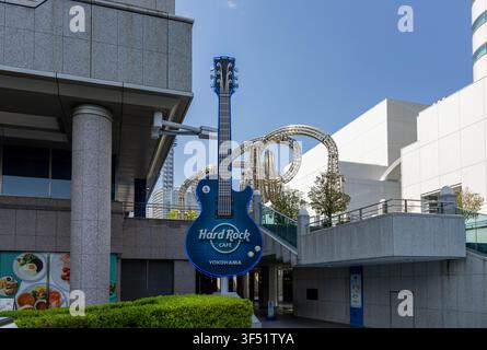 Yokohama, Japan - April 16th, 2026: The  Hard Rock Cafe iconic guitar and the Stainless steel sculpture between Yokohama Landmark Tower and Queen's To Stock Photo