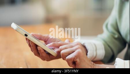 Hands, typing and old woman in home with phone, retirement plan and AI chatbot on insurance website. Senior person, scroll and tech in house with Stock Photo