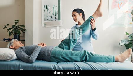 Physio, checkup and stretching leg with old woman, assessment and recovery from injury. Physiotherapist, helping or senior person at clinic for Stock Photo