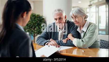 Financial advisor, documents and senior couple in office with life insurance policy for survey. Talking, paperwork and accountant with elderly man and Stock Photo