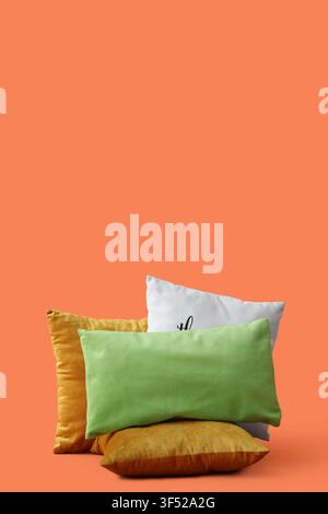 Decorative pillows on orange background Stock Photo
