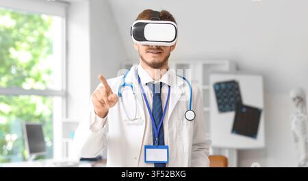 Male doctor wearing virtual reality headset and pointing finger, medical technology and innovation in healthcare Stock Photo